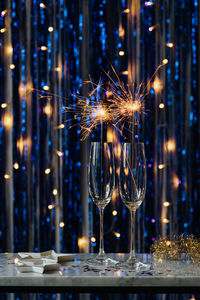 Wine glass on table at night