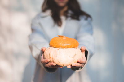 Midsection of woman holding ice cream