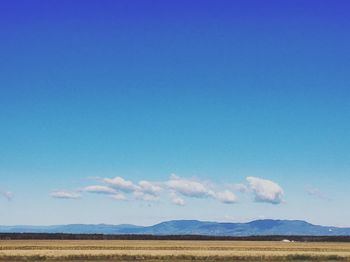 View of countryside landscape against blue sky