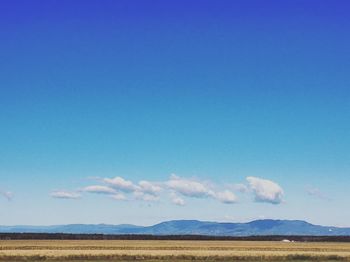 Scenic view of landscape against blue sky