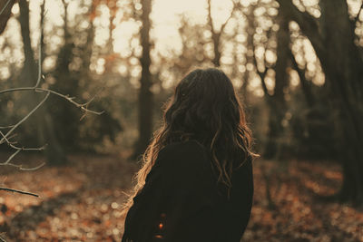 Rear view of woman in forest