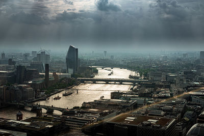 View of cityscape against cloudy sky