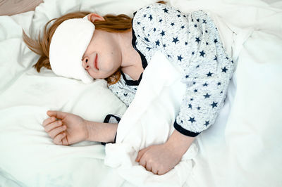 High angle view of baby boy sleeping on bed