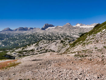 Scenic view of mountains against clear blue sky