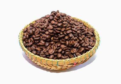 High angle view of coffee beans against white background