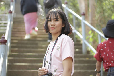 Portrait of smiling girl standing on steps