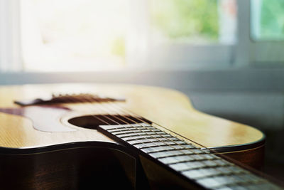 Close-up of guitar on table at home