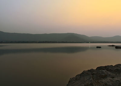 Scenic view of lake against sky during sunset