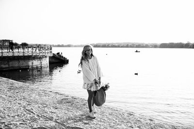 Man standing in sea against clear sky