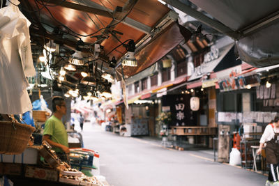 People at market stall in city