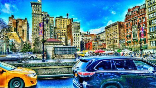 Buildings in city against cloudy sky