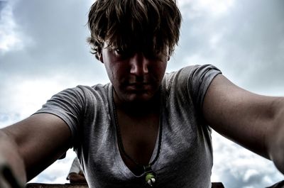 Low angle view of woman standing against sky