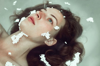 Close-up of beautiful young woman in bathtub