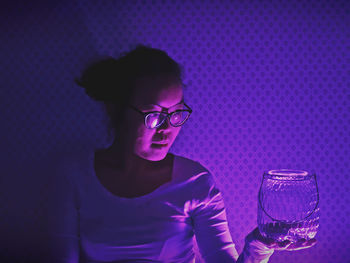 Close-up of young woman wearing eyeglasses on table