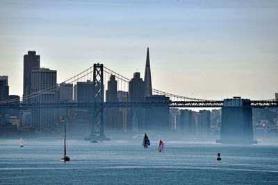 Suspension bridge over river against sky