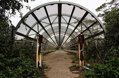 People walking on footpath by bridge