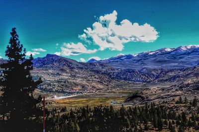 Scenic view of mountains against blue sky