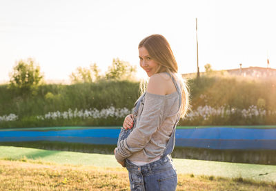 Side view of woman standing on field