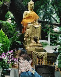 Rear view of statue against temple