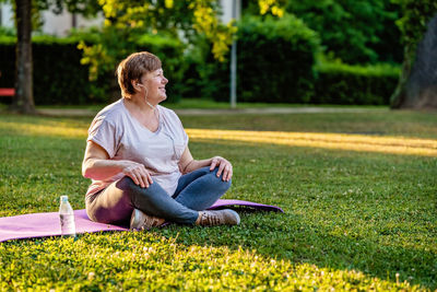 Young woman sitting on grass