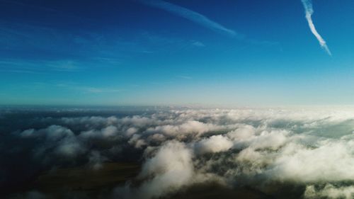 Aerial view of landscape against blue sky