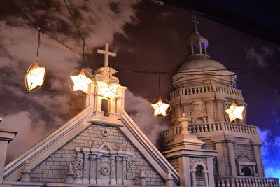 Low angle view of illuminated building against sky