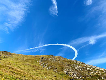 Low angle view of vapor trail against blue sky
