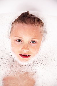 Close-up portrait of young boy bathing