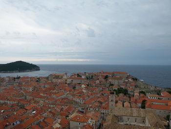 High angle view of buildings by sea against sky in old town