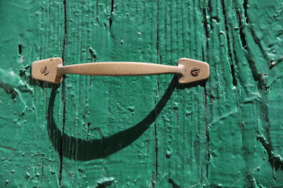 Close-up of handle on old wooden door