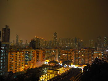 Illuminated cityscape against sky at night