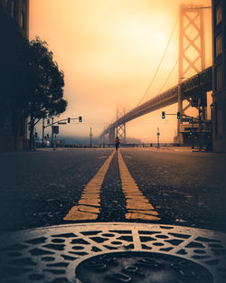 Surface level view of bridge against cloudy sky