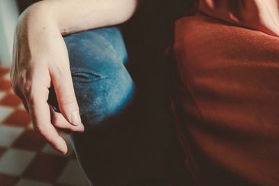 Close-up of hands on woman at home