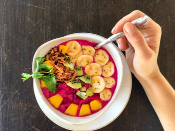 Directly above shot of man holding fruits in bowl