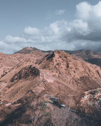 Scenic view of arid landscape against sky