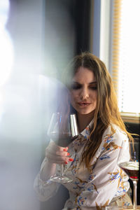 Portrait of young woman drinking glass