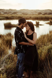 Rear view of couple standing in water