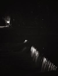 Illuminated tunnel at night