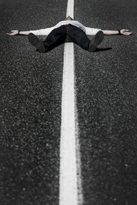 High angle view of man lying on road