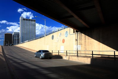 Car on street against buildings in city