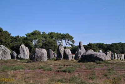 Rocks on field against clear sky