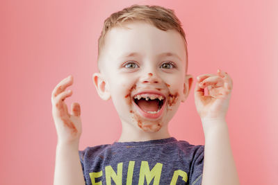 Portrait of cute boy against gray background