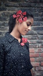 Midsection of woman standing against red wall