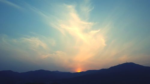Scenic view of silhouette mountains against sky during sunset