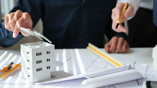 Midsection of businessman working on table