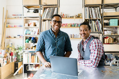 Portrait of happy businessmen working in office