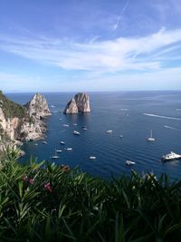 Scenic view of sea and mountains against sky