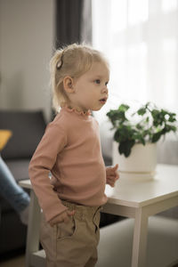 Portrait of cute girl looking away at home