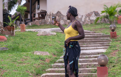 Side view of young woman exercising in park