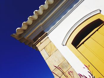 Low angle view of building against blue sky